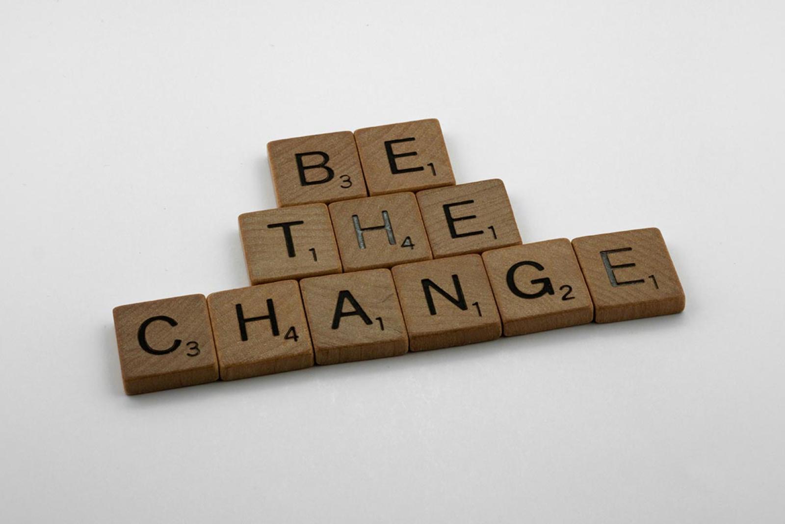 Scrabble tiles spelling out the words Be the Change